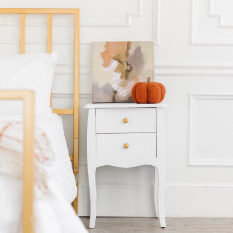 This clean bed and side table is prepped for fall with tips from Zerorez Calgary.
