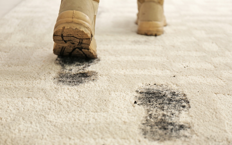Dirty winter boots damaging beige carpet - Call {fran_location_namee} to schedule your next cleaning.