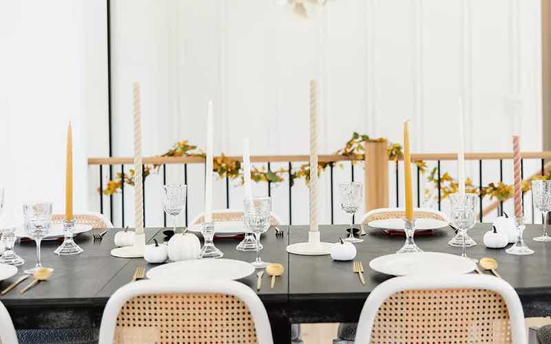 Black and white table arrangment with tall candle sticks.